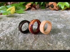 three wooden rings sitting on top of a rock