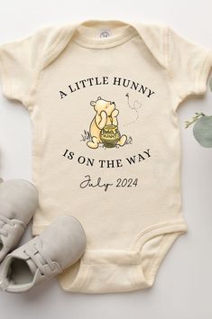 a baby's bodysuit with the words, little hony is on the way