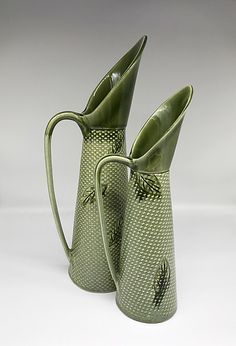 two green vases sitting next to each other