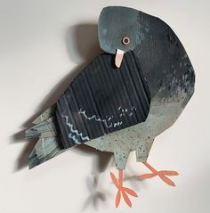 a bird made out of corrugated paper sitting on top of a table