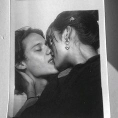 an old photo of two women kissing each other