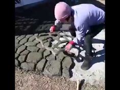 a man working on some kind of tire in the dirt with a wrench and hammer