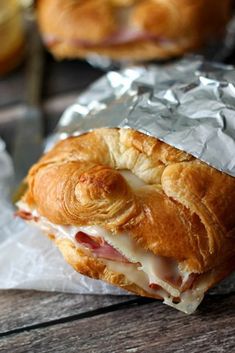 a ham and cheese croissant wrapped in aluminum foil