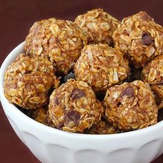 a bowl filled with granola balls on top of a table