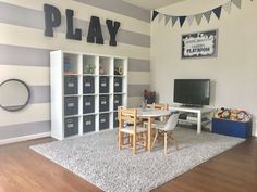 a playroom with gray and white striped walls