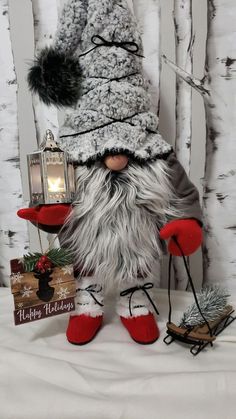 a stuffed gnome with a lantern and some presents