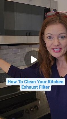 a woman is standing in front of an oven with her arms out and the words how to clean your kitchen exhaust filter