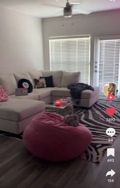 a cat sitting on a bean bag chair in a living room with zebra print rug