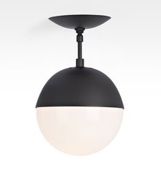 a black and white light hanging from the ceiling