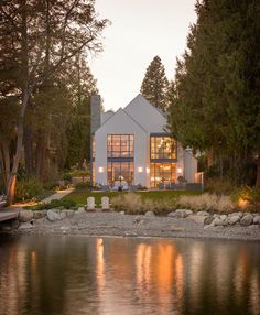 a house sitting on the shore of a lake