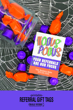 there are candy wrapped in plastic wrappers and on the table is a sign that says, you're referals are our focus