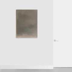 an empty room with two paintings on the wall and one painting hanging in the corner