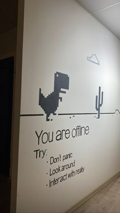 an office wall with the words you are offline written on it and a dinosaur