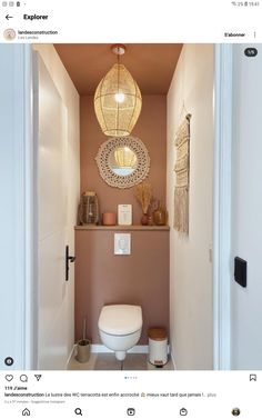 a white toilet sitting inside of a bathroom next to a doorway