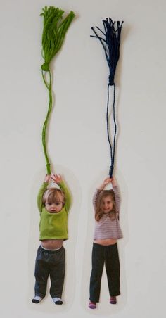 two young children are hanging on the wall