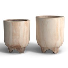 two wooden vases sitting next to each other