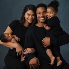 a man, woman and child are posing for a family photo with their arms around each other