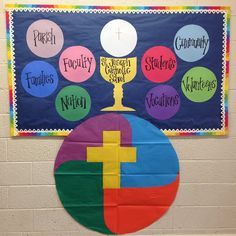a bulletin board on the wall with different colors and shapes in front of it,