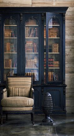 an antique french bookcase with books in it