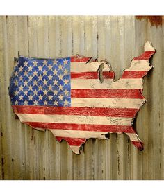 an american flag painted on the side of a metal wall with rusted corrugated sheets