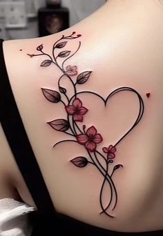 the back of a woman's shoulder with flowers and leaves on it, as well as a heart