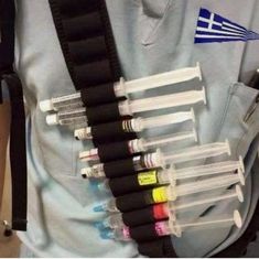 a person holding an assortment of different colored inks in their back pocket with the flag of greece on it
