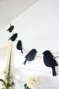 some black birds are hanging on a string