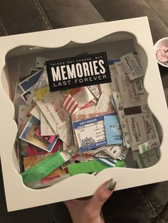 someone is holding up a box full of old movies and ticket stuks from the movie'memories last forever '