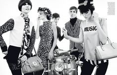 four models in animal print outfits with handbags and purses on their heads, standing next to each other