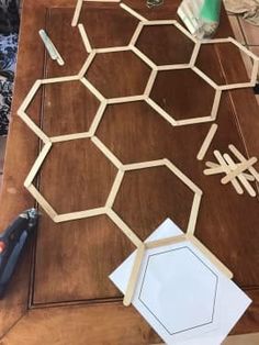 the table is covered with cut out pieces of wood and glue to make hexagons