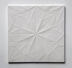 an abstract white paper sculpture on a wall