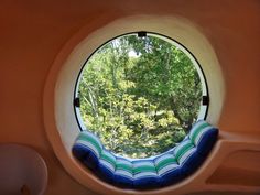 a round window with a blue and white couch in it