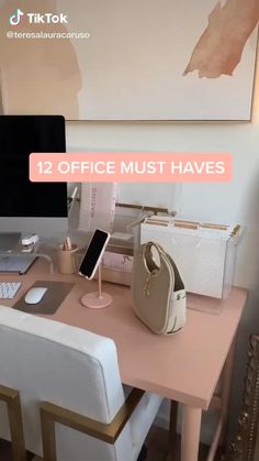 a desk with a computer, phone and purse on it