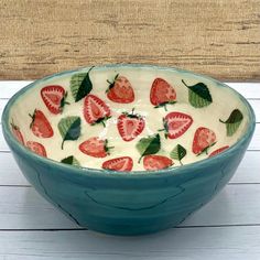 a bowl with strawberries painted on it