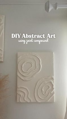 a white wall with some art on it and the words diy abstract art using paint compound