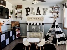 a playroom with black and white striped walls