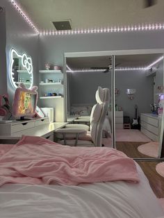 a bedroom decorated in pink and white with hello kitty decorations on the walls, lights above the bed