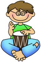 a boy sitting on the floor with his hands up and holding a drum in front of him