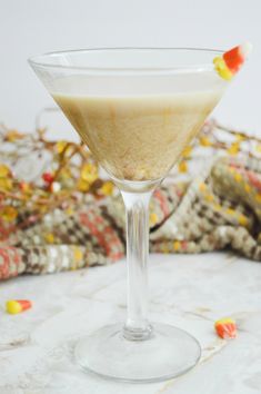 a martini glass with candy corn on the rim