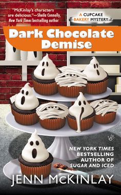 a book cover with cupcakes on a cake stand and the title dark chocolate demise