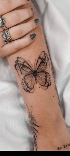 a woman's arm with a butterfly tattoo on it