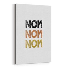 a white canvas with the words nom, nom on it in multicolored letters