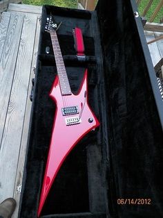 a red electric guitar in a black case