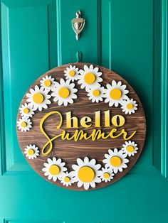 a wooden sign that says hello summer with daisies in the center on a green door
