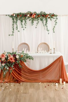 the table is decorated with flowers and candles for an elegant dinner party or wedding reception