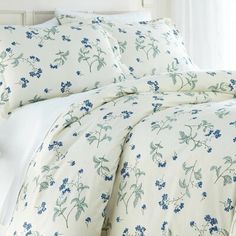 a white bed with blue flowers on it