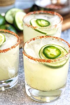 three glasses filled with cucumber and lime margaritas