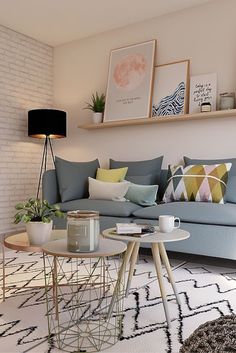 a living room filled with furniture next to a white brick wall in the background is a coffee table and potted plant
