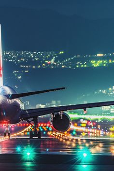 an airplane is on the runway at night