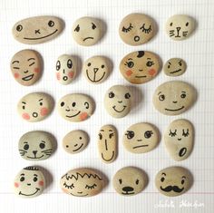 a bunch of rocks with faces painted on them